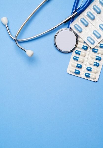 Premium Photo | Blister of pills capsiles and stethoscope isolated on blue background